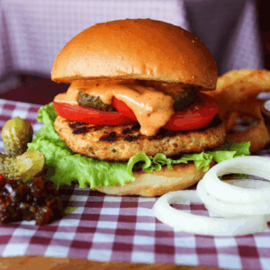 Belle Vue Burger, cheesburger, with spicy nduja sausage, gherkins, onion rings & burger relish.